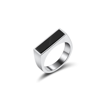 Sleek and modern silver signet ring with a rectangular black onyx inlay. The ring's design features clean lines and a high polish finish, highlighting the reflective quality of the metal against the deep black stone, all set against a pristine white background