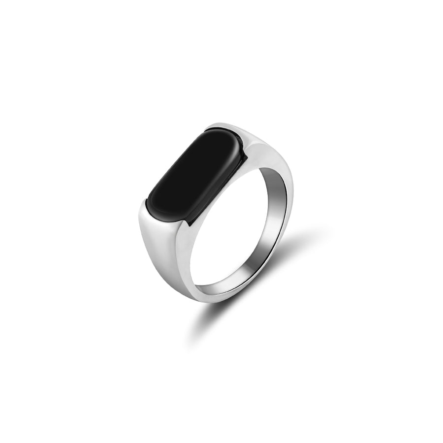 Contemporary silver signet ring with an elongated black onyx centerpiece set on a curved, polished band. The onyx's smooth, oblong shape provides a modern take on classic signet rings, set against a pure white backdrop, highlighting its sleek design and lustrous metal finish