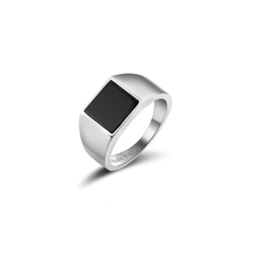 Classic silver signet ring featuring a square-cut black onyx stone. The thick band tapers towards the back, and the metal is marked with the jeweler's hallmark. The design is both timeless and modern, presented against a white background to accentuate the contrast between the silver and the black onyx